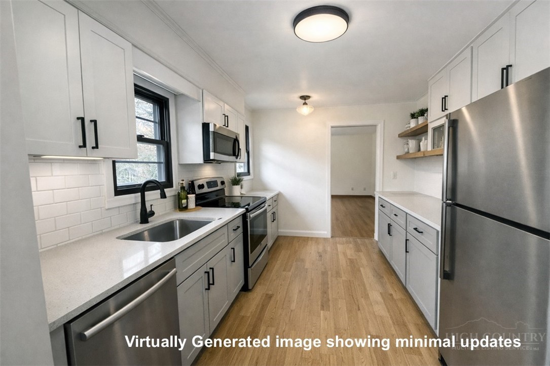 2510 Rich Hill Road Creston, NC 28615 - Photo 11 of 38 a kitchen with white cabinets and stainless steel appliances
