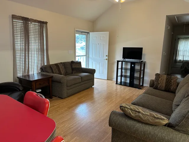 a living room with furniture and a flat screen tv