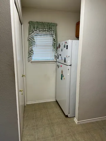a view of a refrigerator in kitchen and dishwasher
