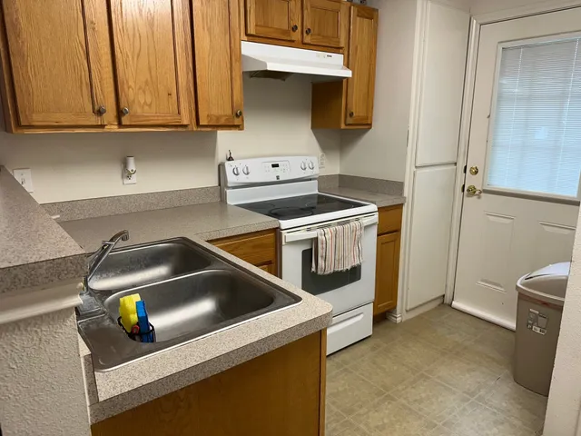 a kitchen with a stove and a cabinet