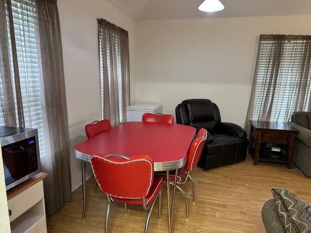 a dining room with furniture and window