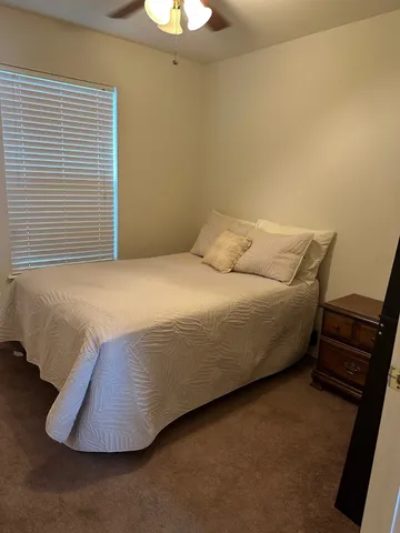 a bedroom with a bed and a chair