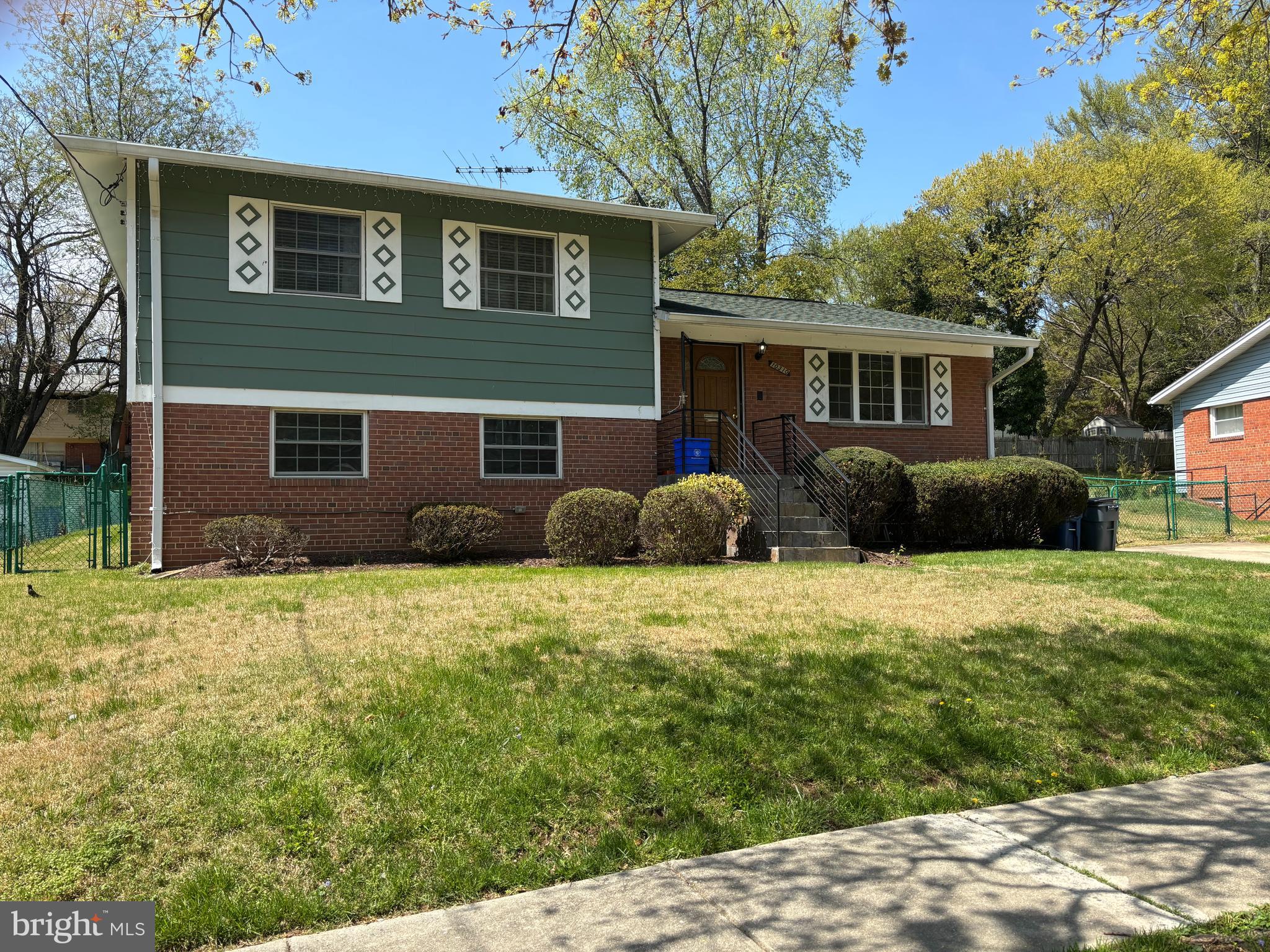 10310 Royal Road Silver Spring, MD 20903 - Photo 1 of 61 a front view of a house with a yard and garage