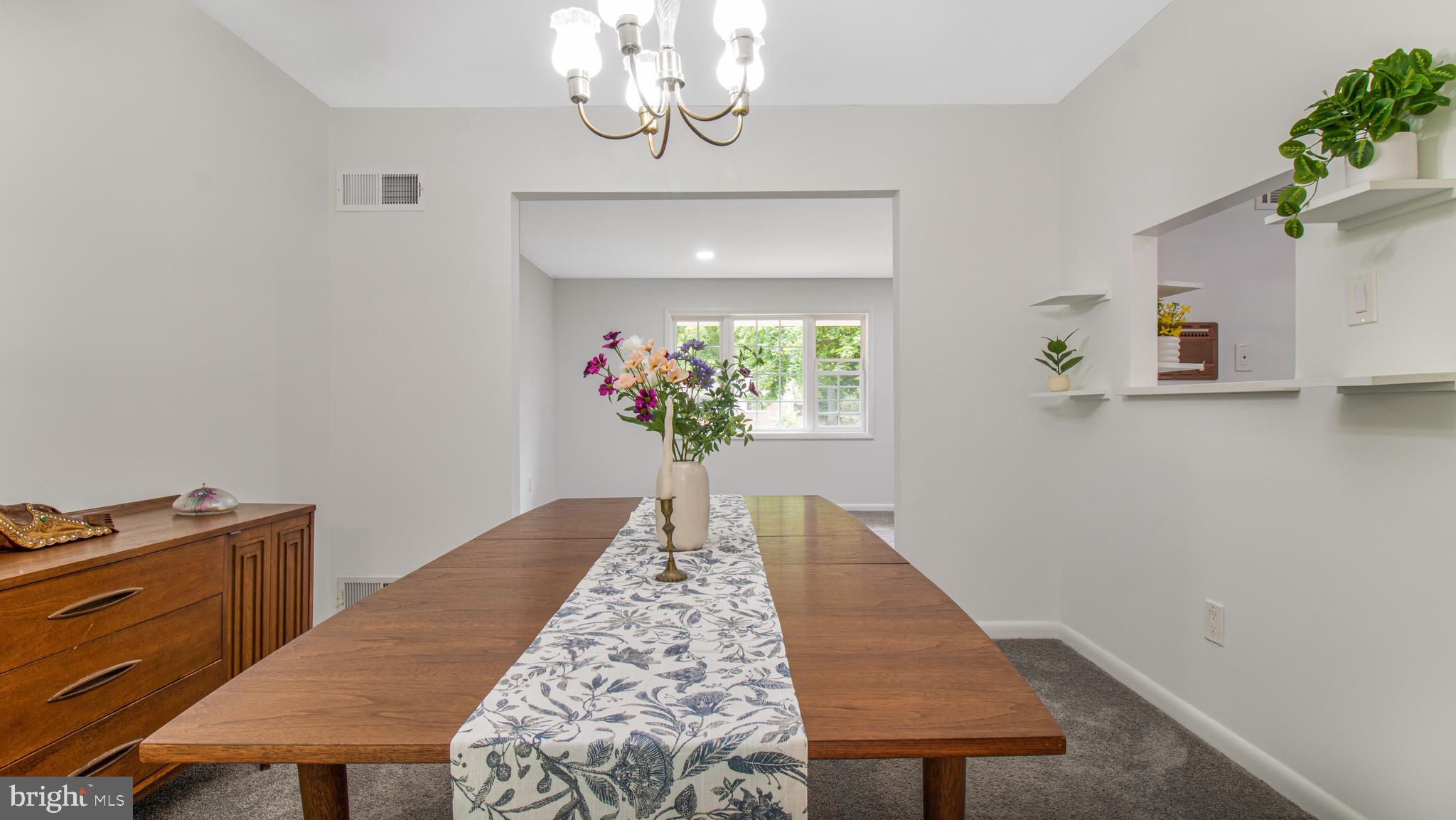 10310 Royal Road Silver Spring, MD 20903 - Photo 11 of 61 a dining room with a table and chandelier