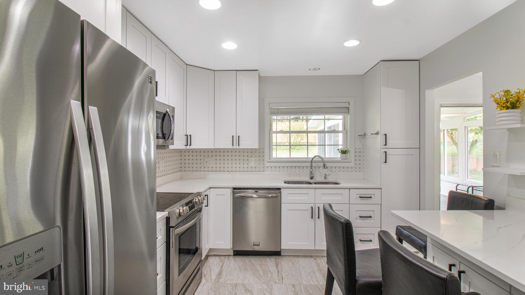 10310 Royal Road Silver Spring, MD 20903 - Photo 14 of 61 a kitchen with stainless steel appliances a sink stove and refrigerator