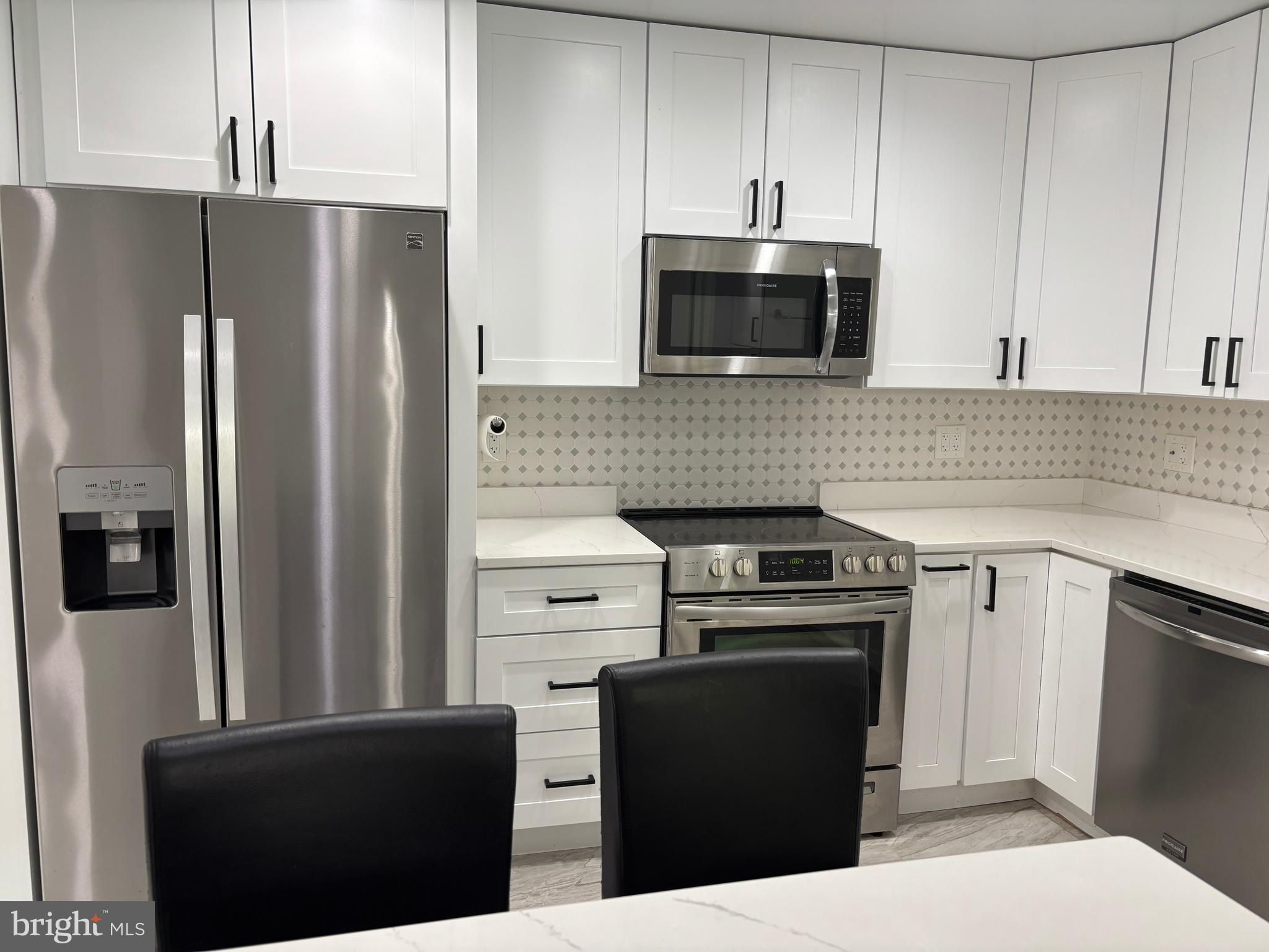 10310 Royal Road Silver Spring, MD 20903 - Photo 20 of 61 a kitchen with stainless steel appliances granite countertop a refrigerator stove and microwave