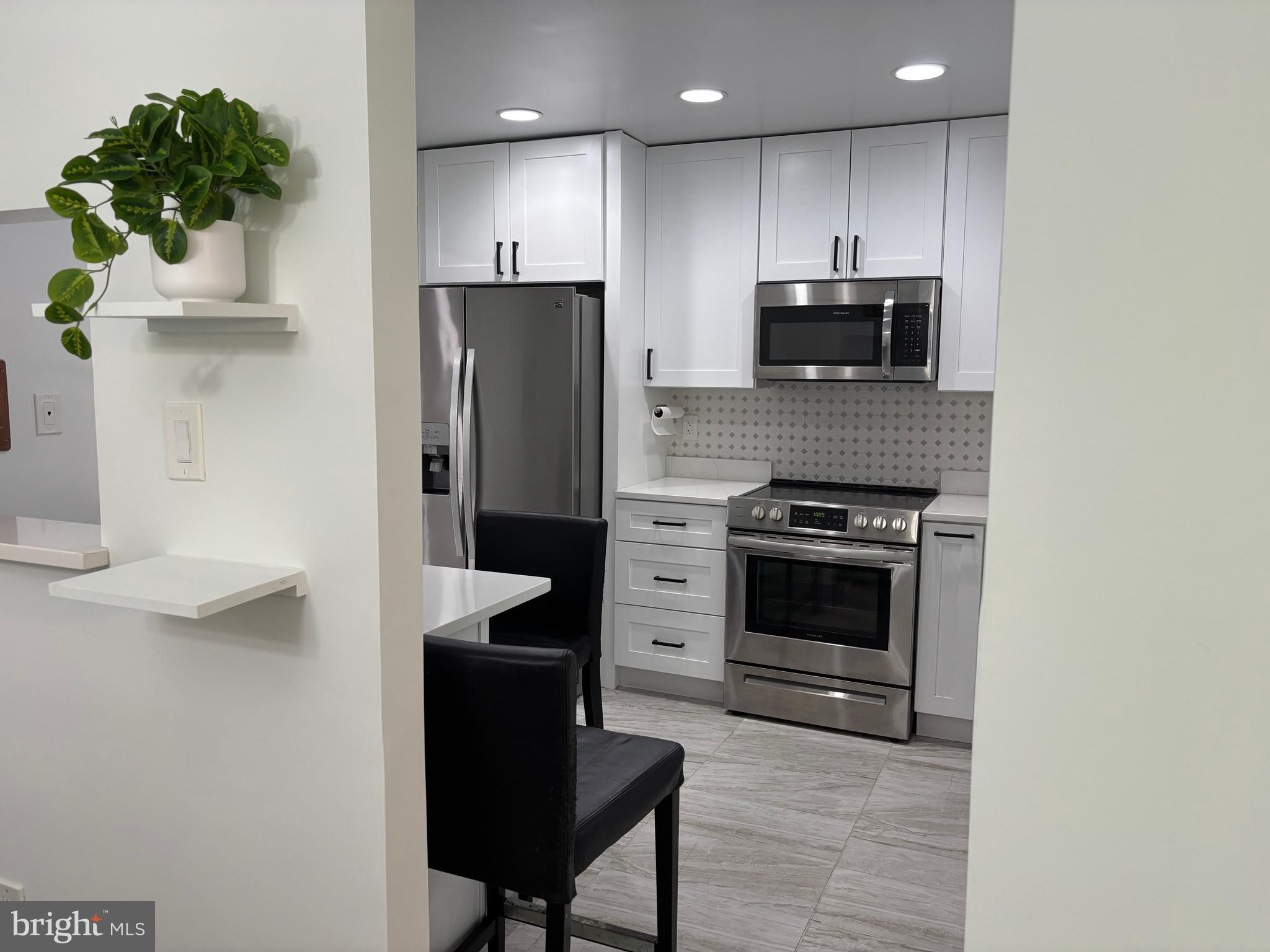 10310 Royal Road Silver Spring, MD 20903 - Photo 22 of 61 a kitchen with kitchen island a counter top space a sink stainless steel appliances and cabinets