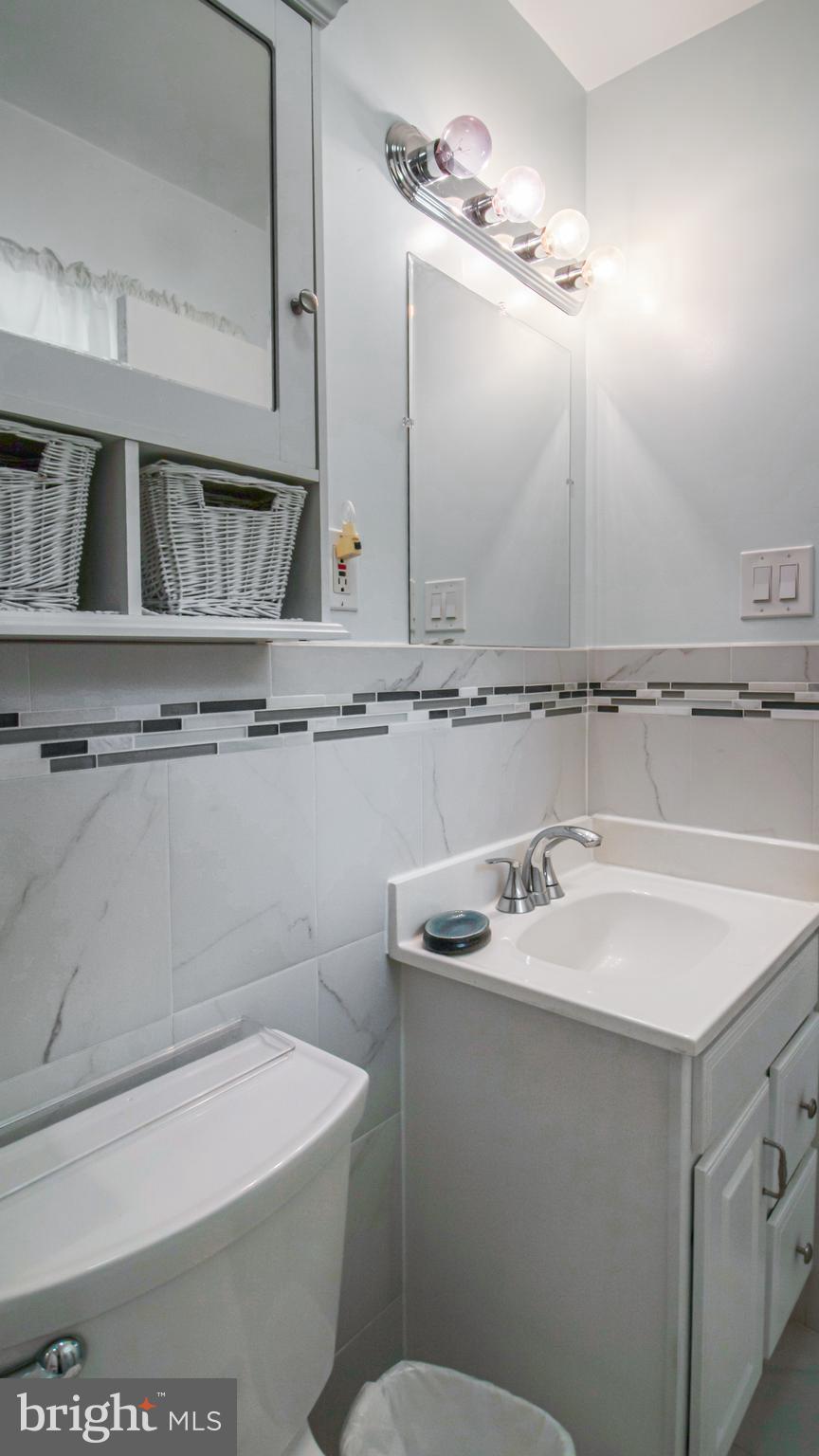 10310 Royal Road Silver Spring, MD 20903 - Photo 27 of 61 a bathroom with a sink a toilet and mirror