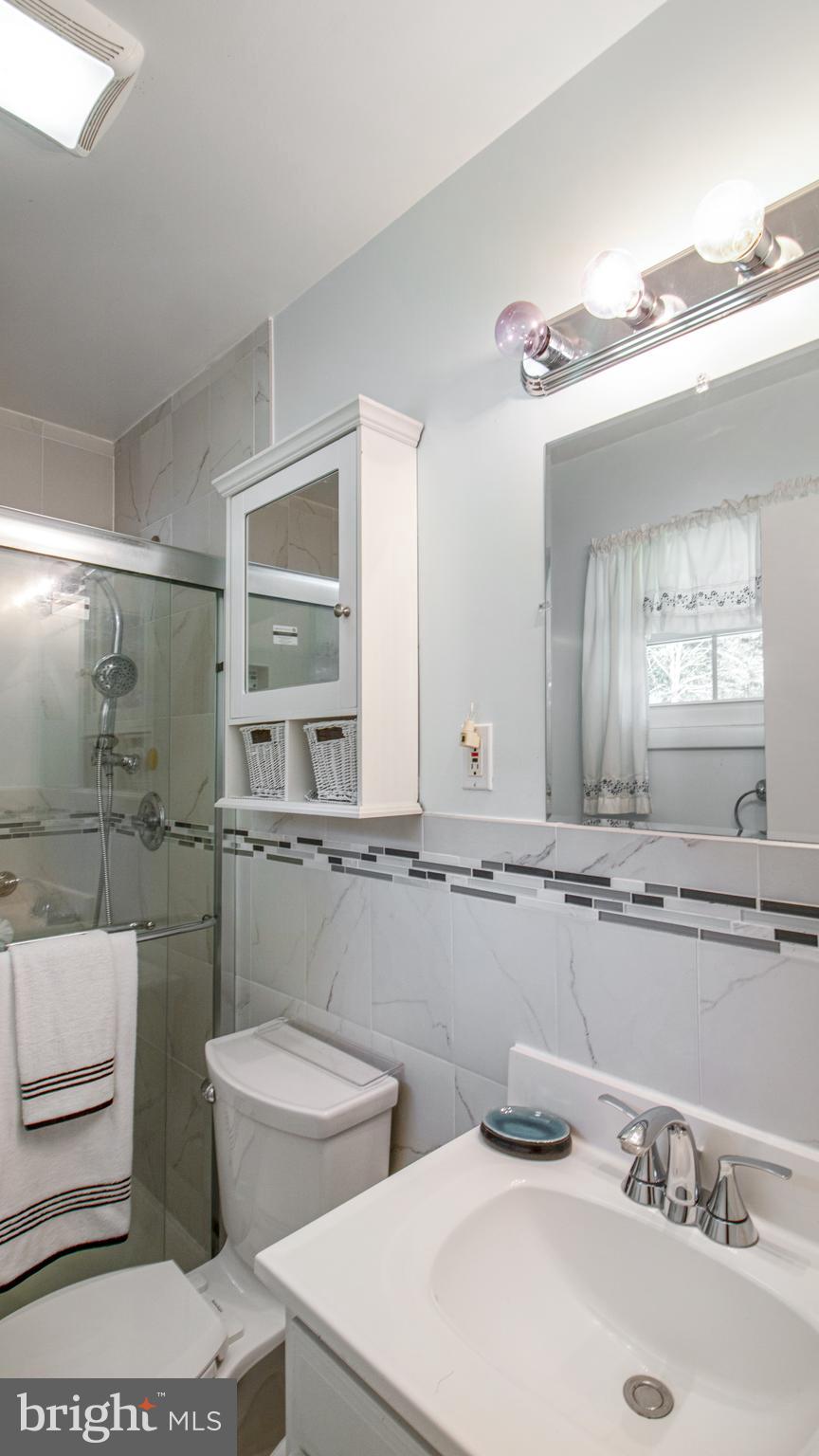 10310 Royal Road Silver Spring, MD 20903 - Photo 28 of 61 a bathroom with a toilet a sink and mirror