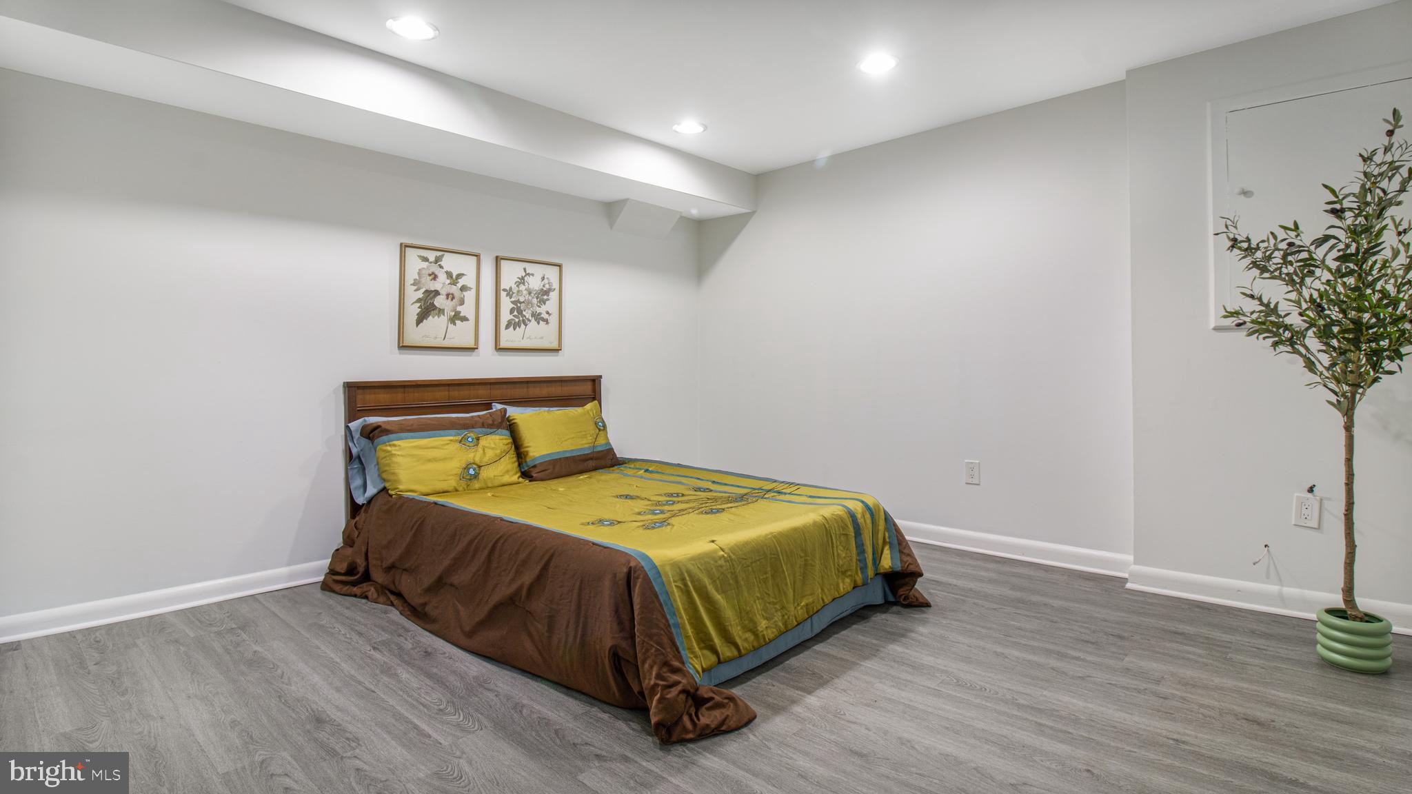 10310 Royal Road Silver Spring, MD 20903 - Photo 39 of 61 a bedroom with a bed and a potted plant