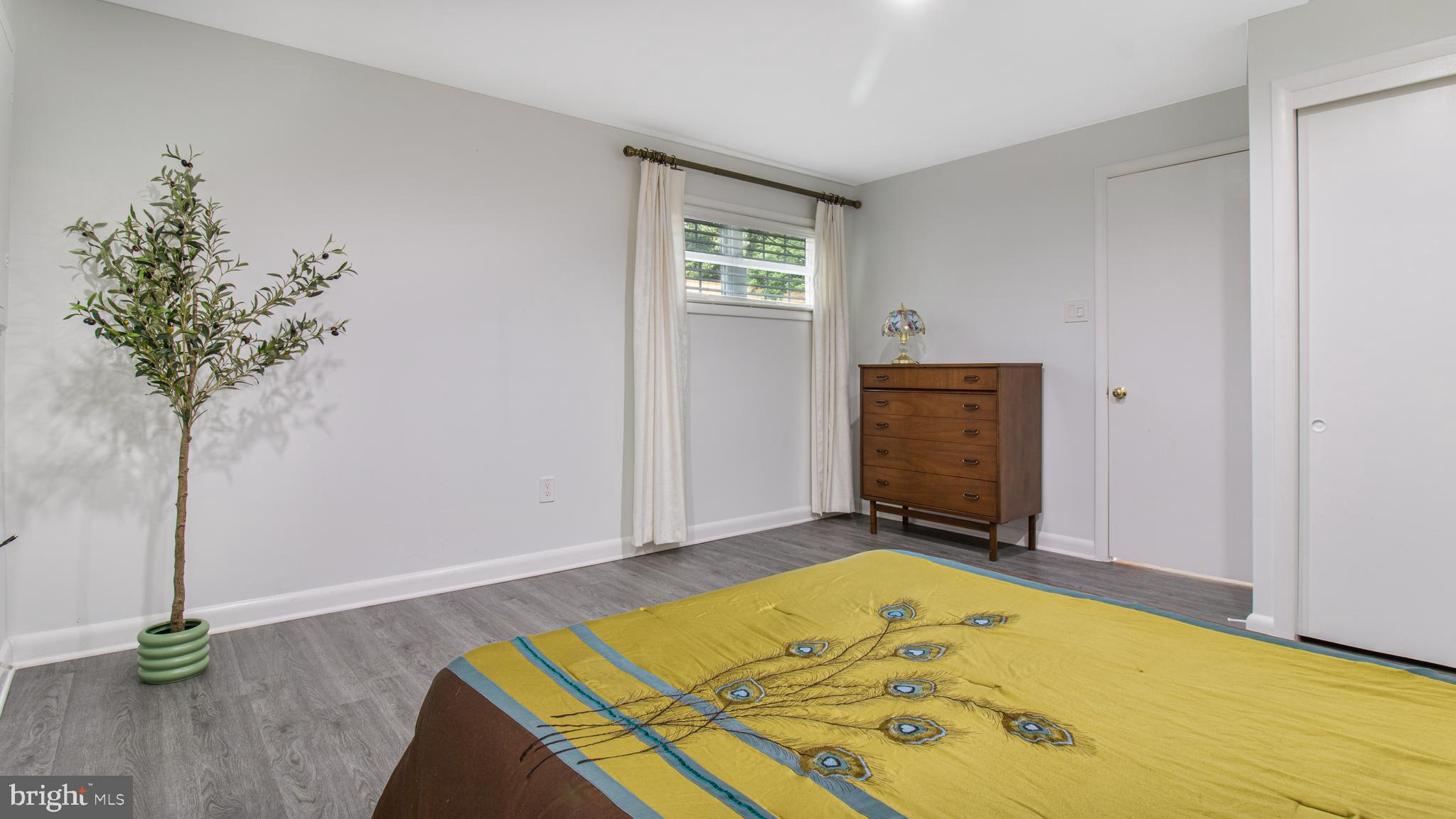 10310 Royal Road Silver Spring, MD 20903 - Photo 40 of 61 a bedroom with a bed and a chandelier