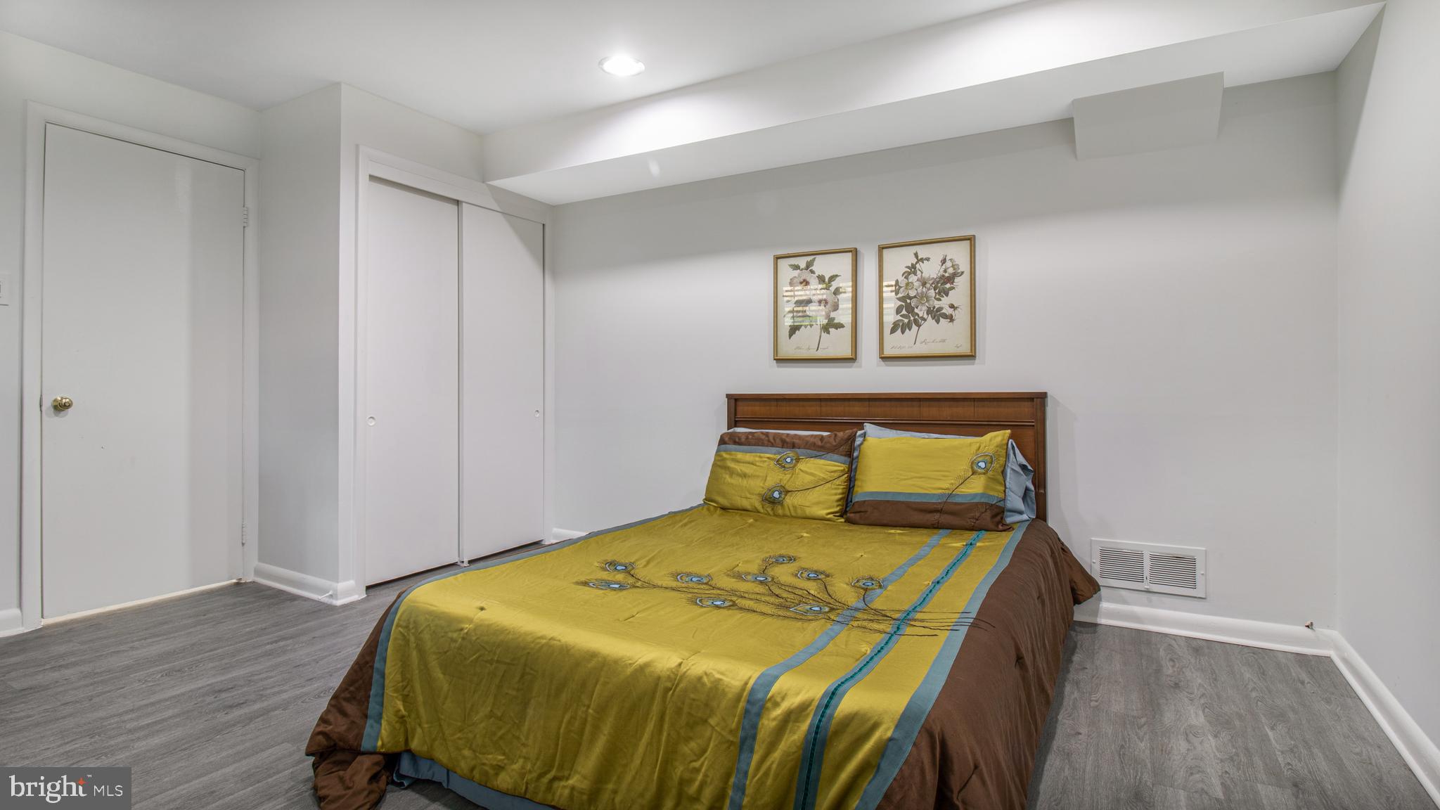 10310 Royal Road Silver Spring, MD 20903 - Photo 42 of 61 a bedroom with a bed and wooden floor