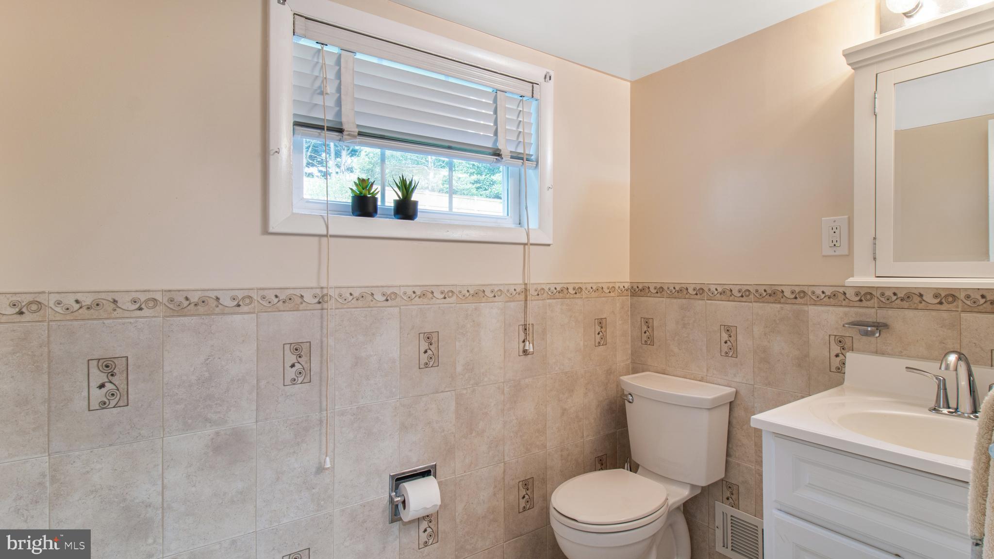 10310 Royal Road Silver Spring, MD 20903 - Photo 43 of 61 a white toilet sitting next to a bathroom sink