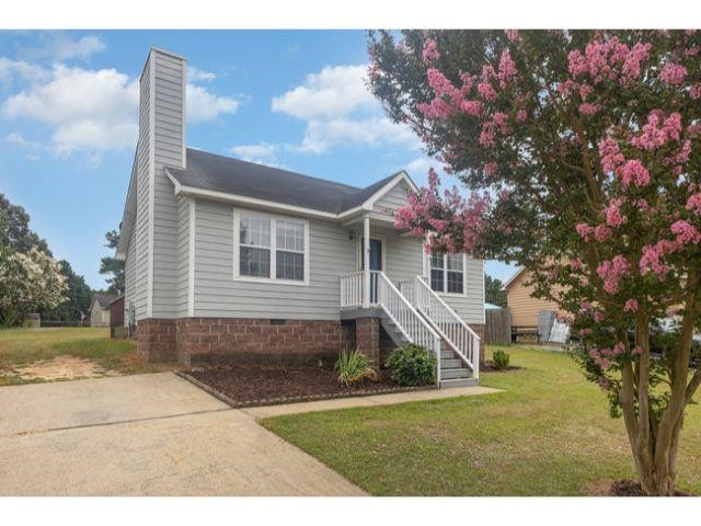 608 Perry Howard Road Fuquay-Varina, NC 27526 - Photo 2 of 21 a front view of a house with garden