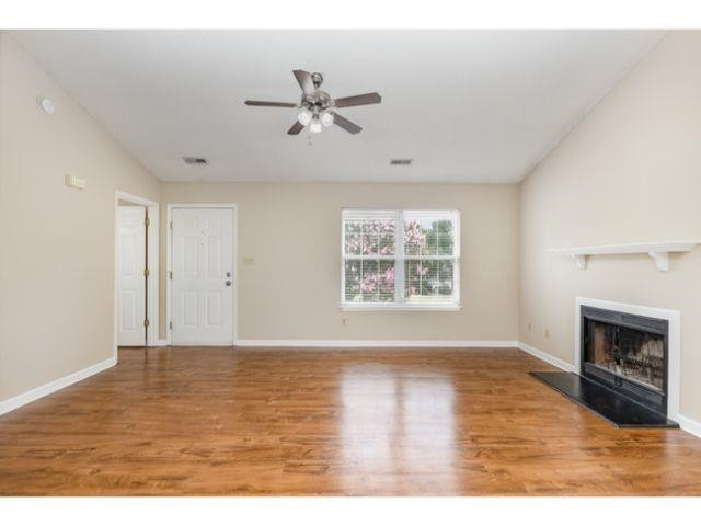 608 Perry Howard Road Fuquay-Varina, NC 27526 - Photo 5 of 21 a view of an empty room with wooden floor and a fireplace