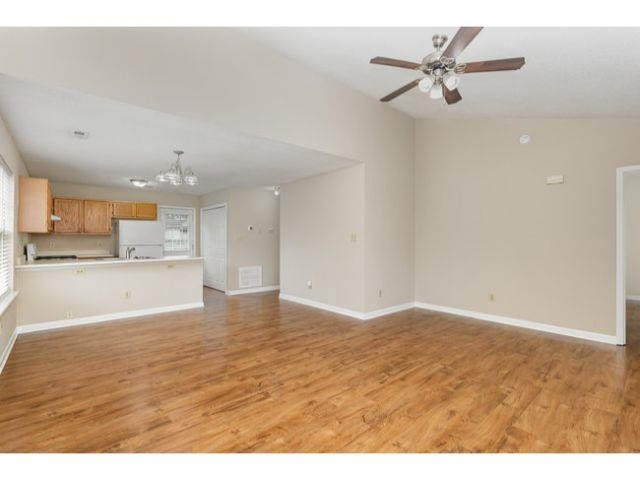 608 Perry Howard Road Fuquay-Varina, NC 27526 - Photo 6 of 21 a view of kitchen and empty room with wooden floor