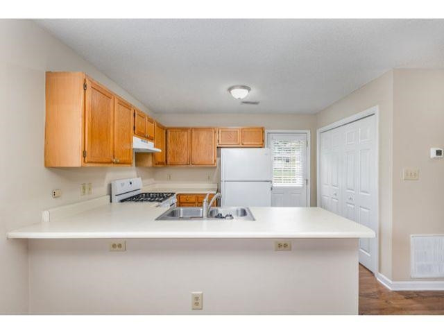 608 Perry Howard Road Fuquay-Varina, NC 27526 - Photo 8 of 21 a kitchen with a sink a stove and cabinets