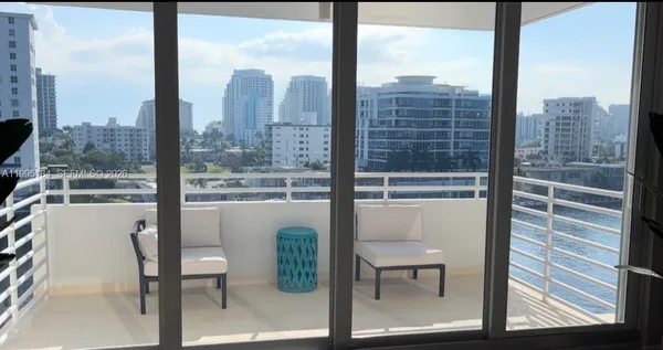 a view of a city from a living room filled with furniture