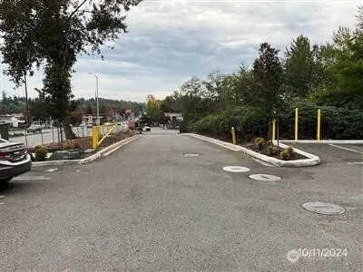 a view of a street with a cars parked on the road