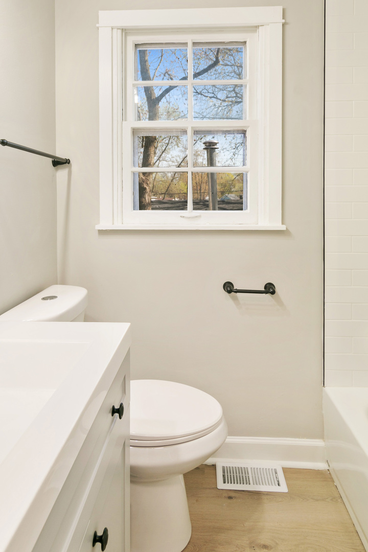 25 Long Beach Road Montgomery, IL 60538 - Photo 12 of 21 a bathroom with a sink a toilet and a window