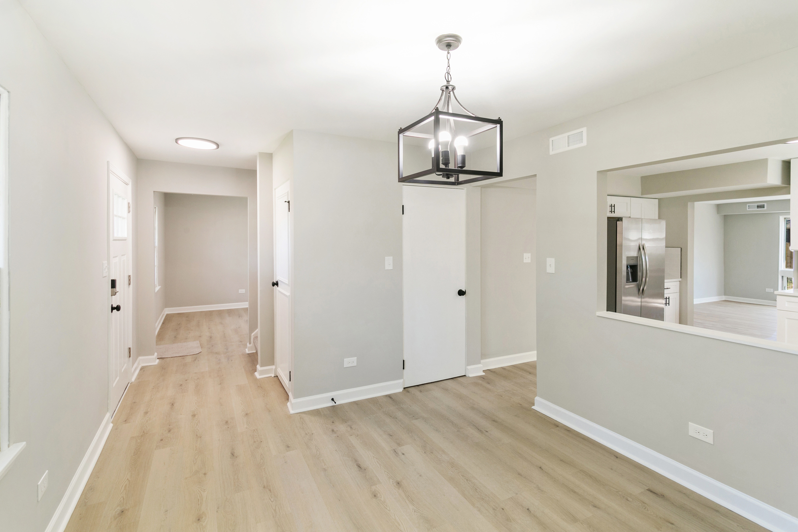 25 Long Beach Road Montgomery, IL 60538 - Photo 3 of 21 a view of a room with wooden floor and wardrobe