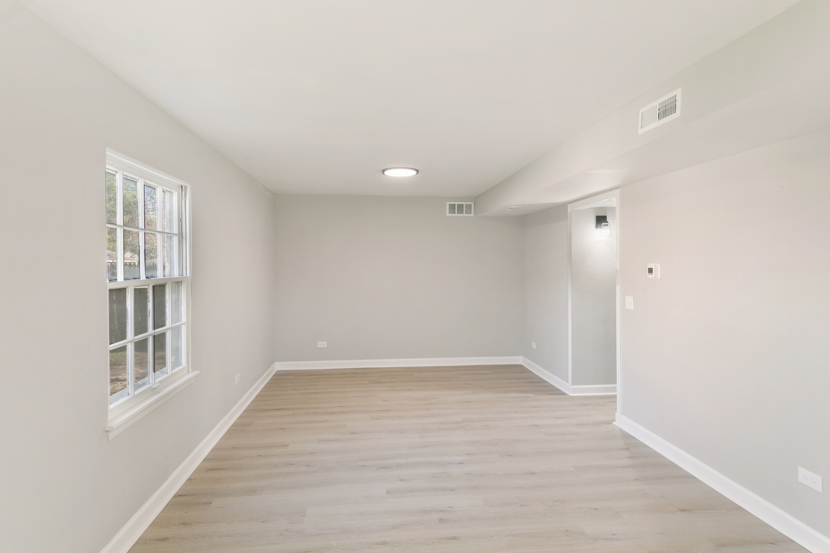 25 Long Beach Road Montgomery, IL 60538 - Photo 5 of 21 wooden floor in an empty room with a window