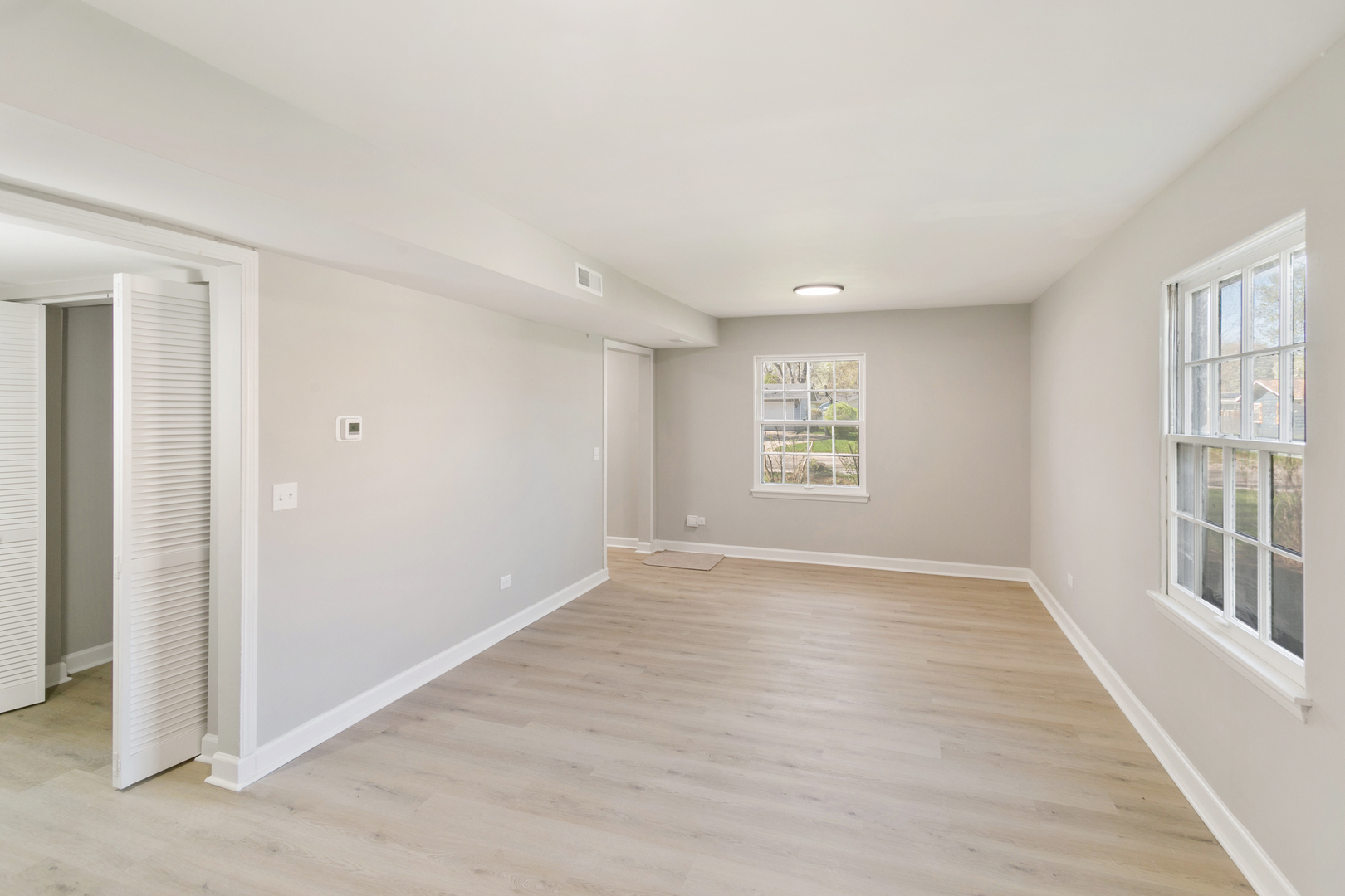 25 Long Beach Road Montgomery, IL 60538 - Photo 6 of 21 an empty room with wooden floor and windows