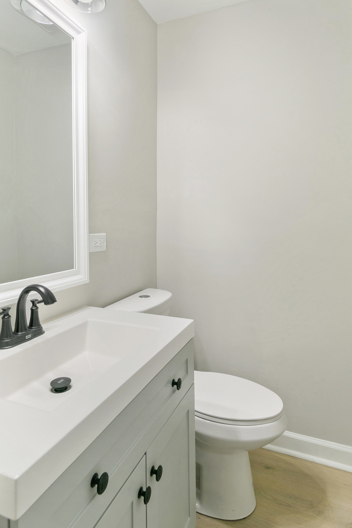 25 Long Beach Road Montgomery, IL 60538 - Photo 8 of 21 a bathroom with a sink a toilet and mirror