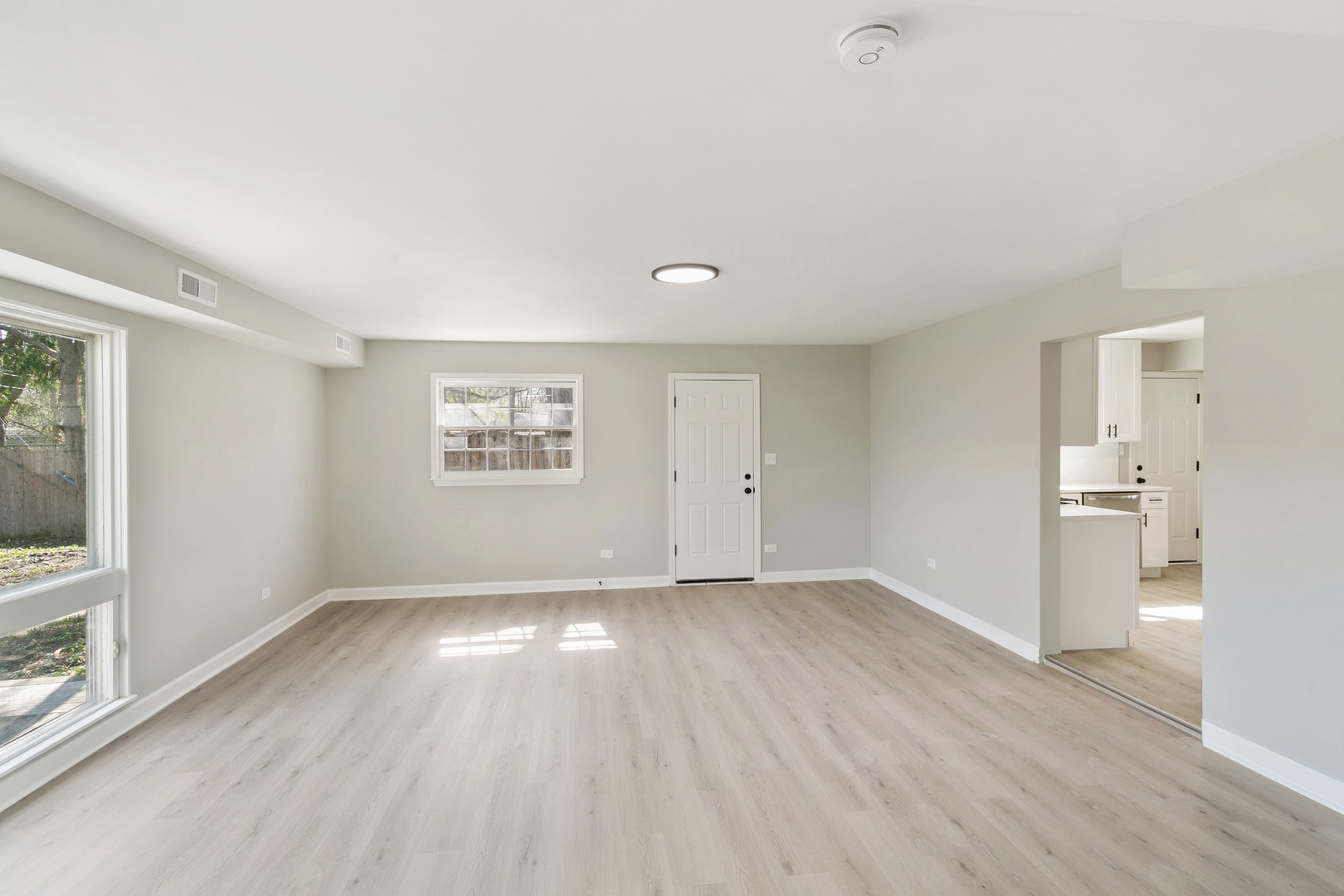 25 Long Beach Road Montgomery, IL 60538 - Photo 10 of 21 an empty room with wooden floor and windows