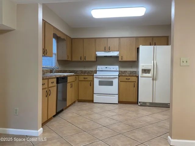 a kitchen with a stove top oven sink and cabinets