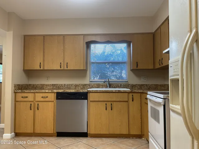 a kitchen with stainless steel appliances granite countertop a stove a sink and a granite counter tops