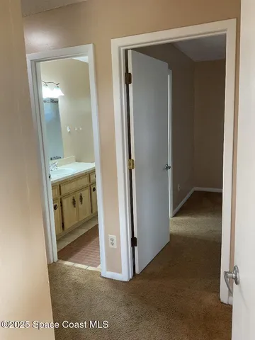 a view of a bathroom from the hallway