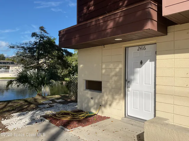 a backyard of a house with barbeque oven table and chairs