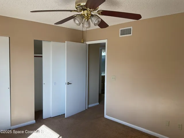 a view of a hallway with a fan