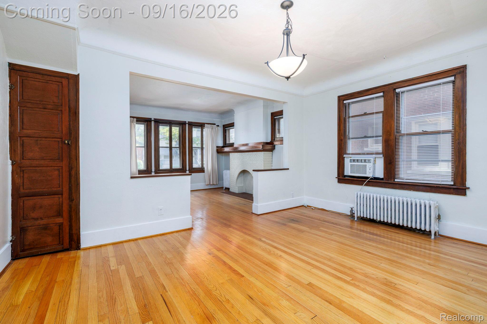 999 Nottingham Road Grosse Pointe, MI 48230 - Photo 14 of 30 Hardwood flooring, painted walls, and white trim throughout