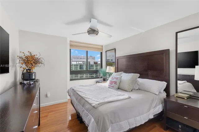 a bedroom with a large bed and a chandelier