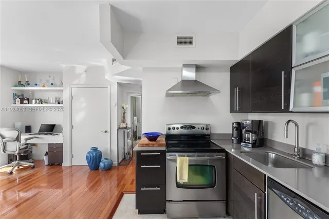 a kitchen with stainless steel appliances a sink stove and refrigerator