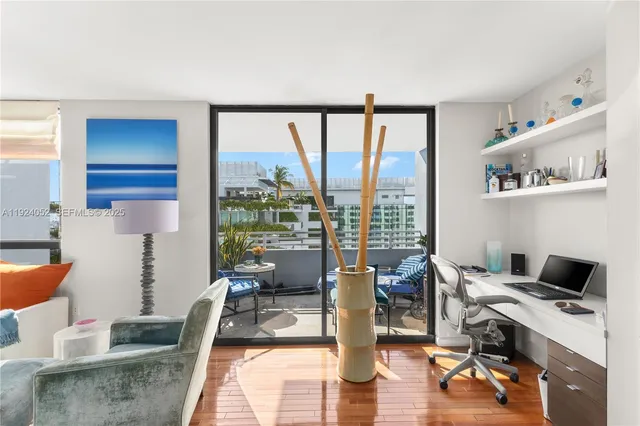 a work room with furniture and large windows