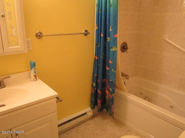 203 Westcolang Road Lackawaxen, PA 18435 - Photo 10 of 15 a bathroom with a bathtub and a shower