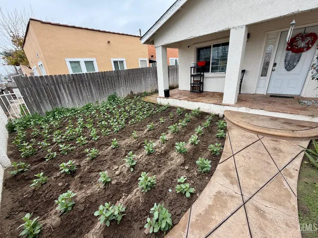 a view of a hallway with wooden floor and a bathroom