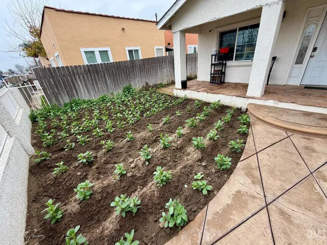 a view of a livingroom with wooden floor and a flat screen tv