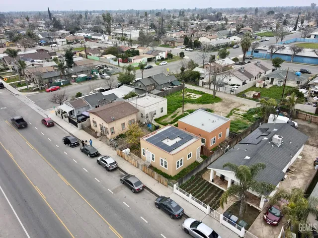 an aerial view of a house with a yard