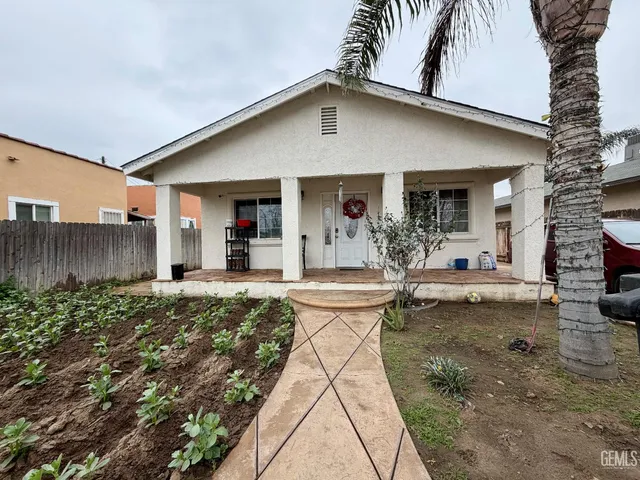a large bed sitting in a bedroom next to a window