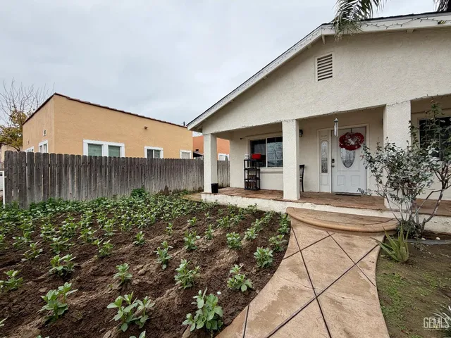 a living room with furniture and a ceiling fan
