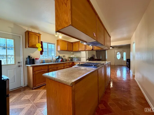 an aerial view of residential houses with outdoor space and parking