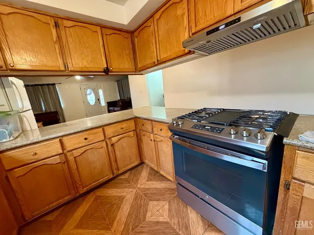 a kitchen with stainless steel appliances granite countertop a sink and cabinets