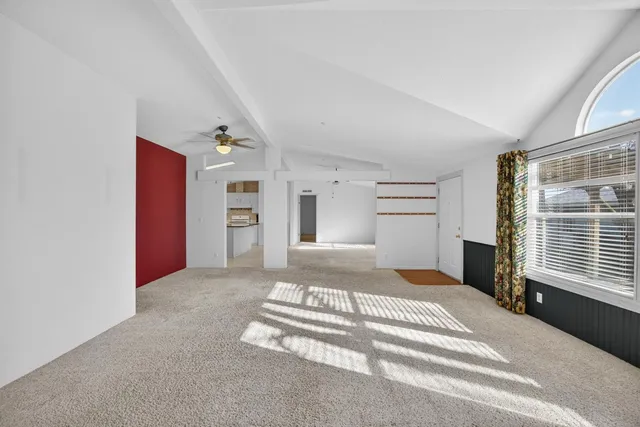 an empty room with a ceiling fan