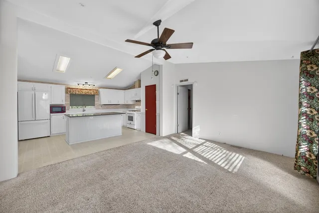 a view of a kitchen with a sink and a window