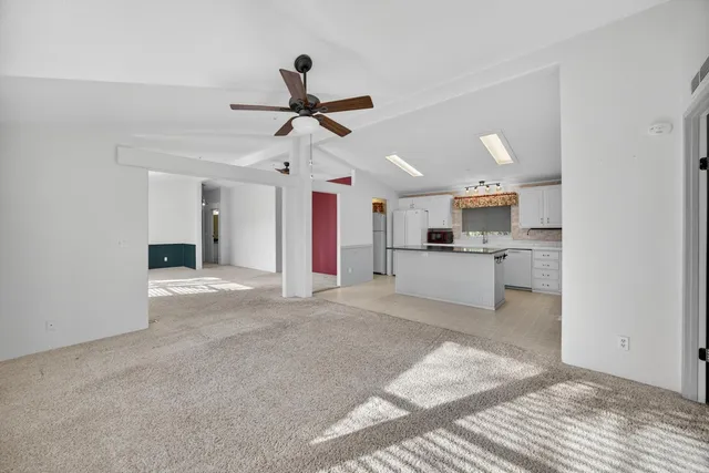 a large white kitchen with cabinets and stainless steel appliances