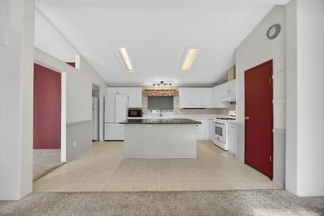 a kitchen with stainless steel appliances granite countertop a refrigerator and a sink